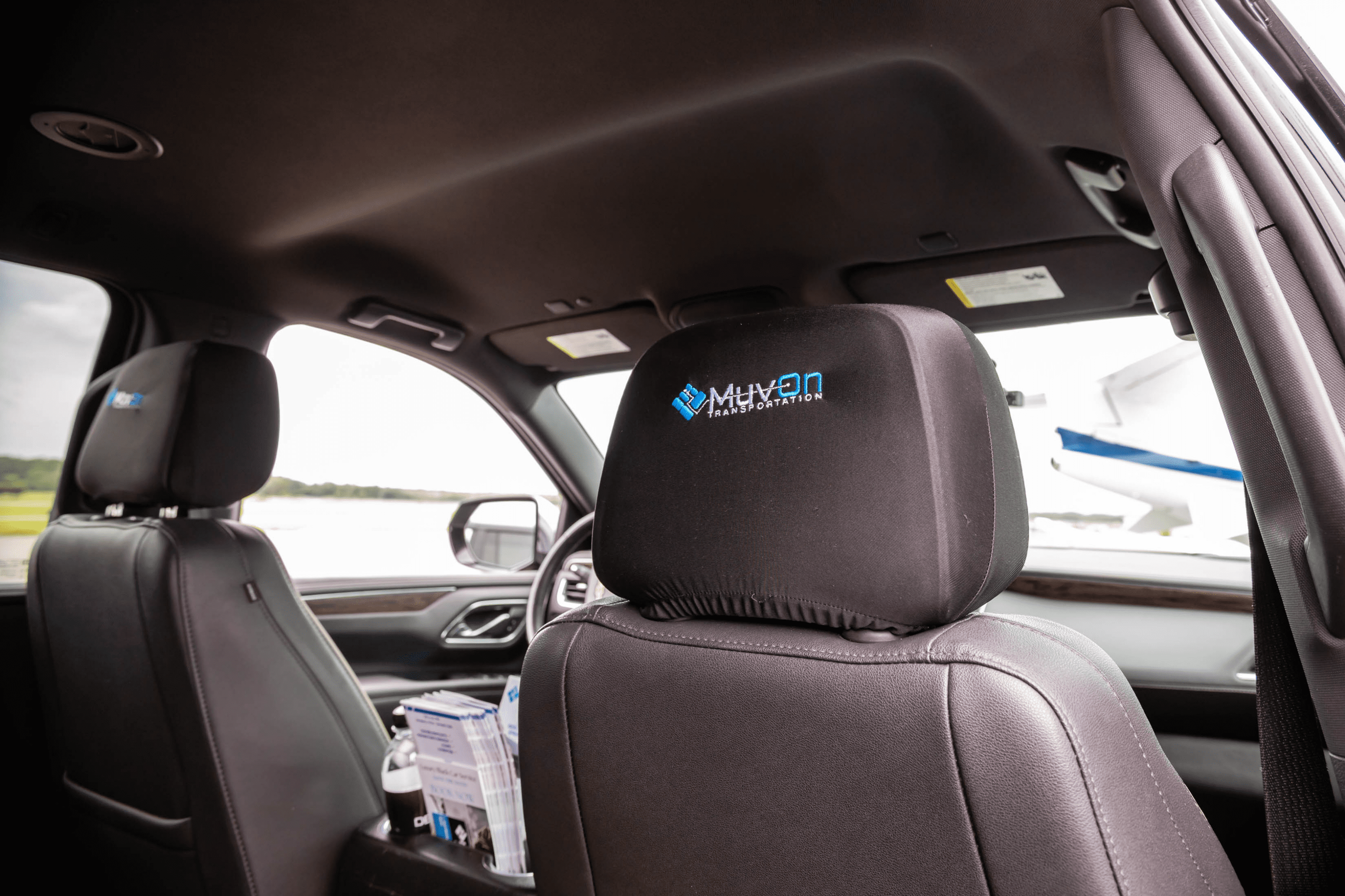 Car interior with Muvon branded headrest cover