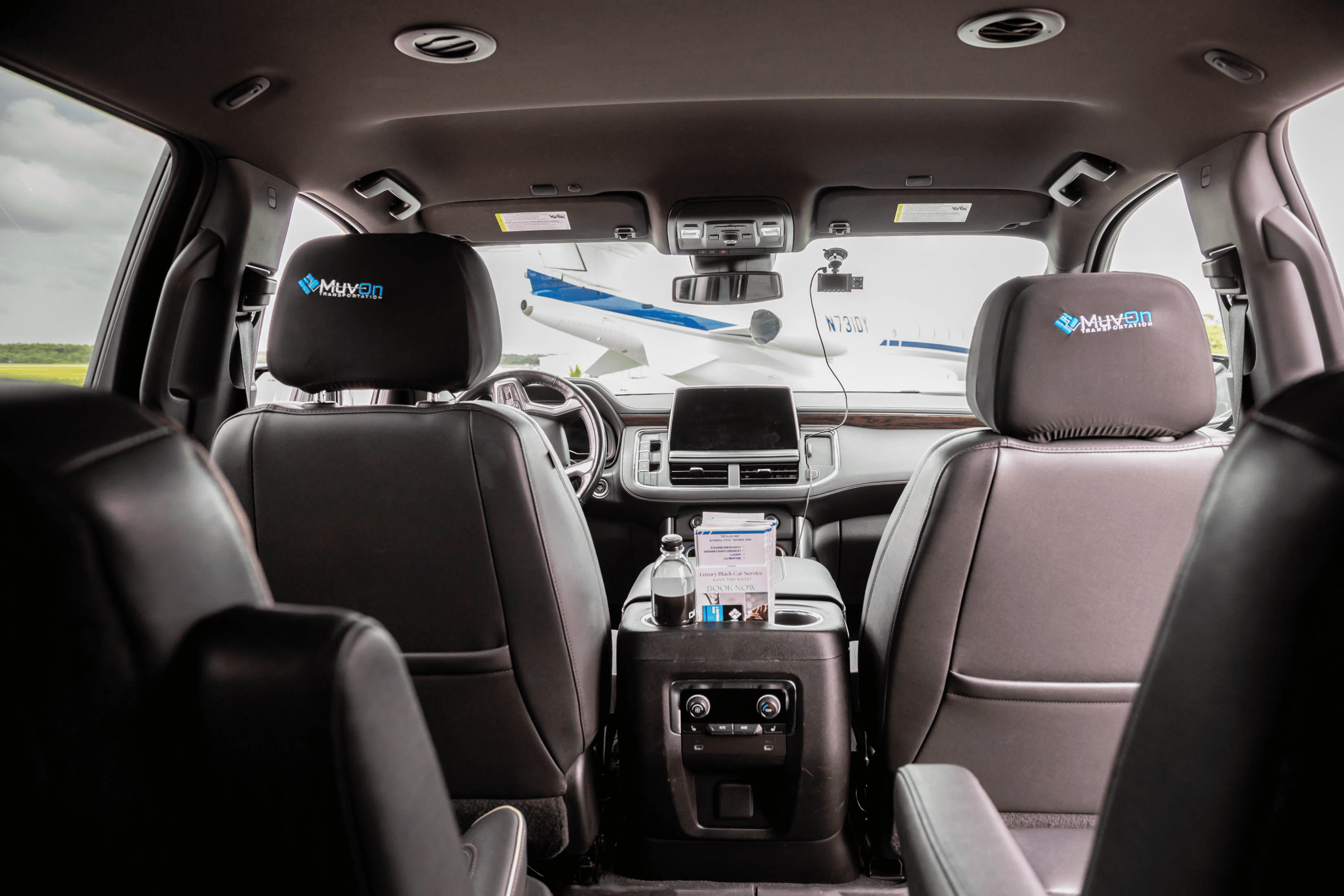 Car interior with airplane visible through windshield