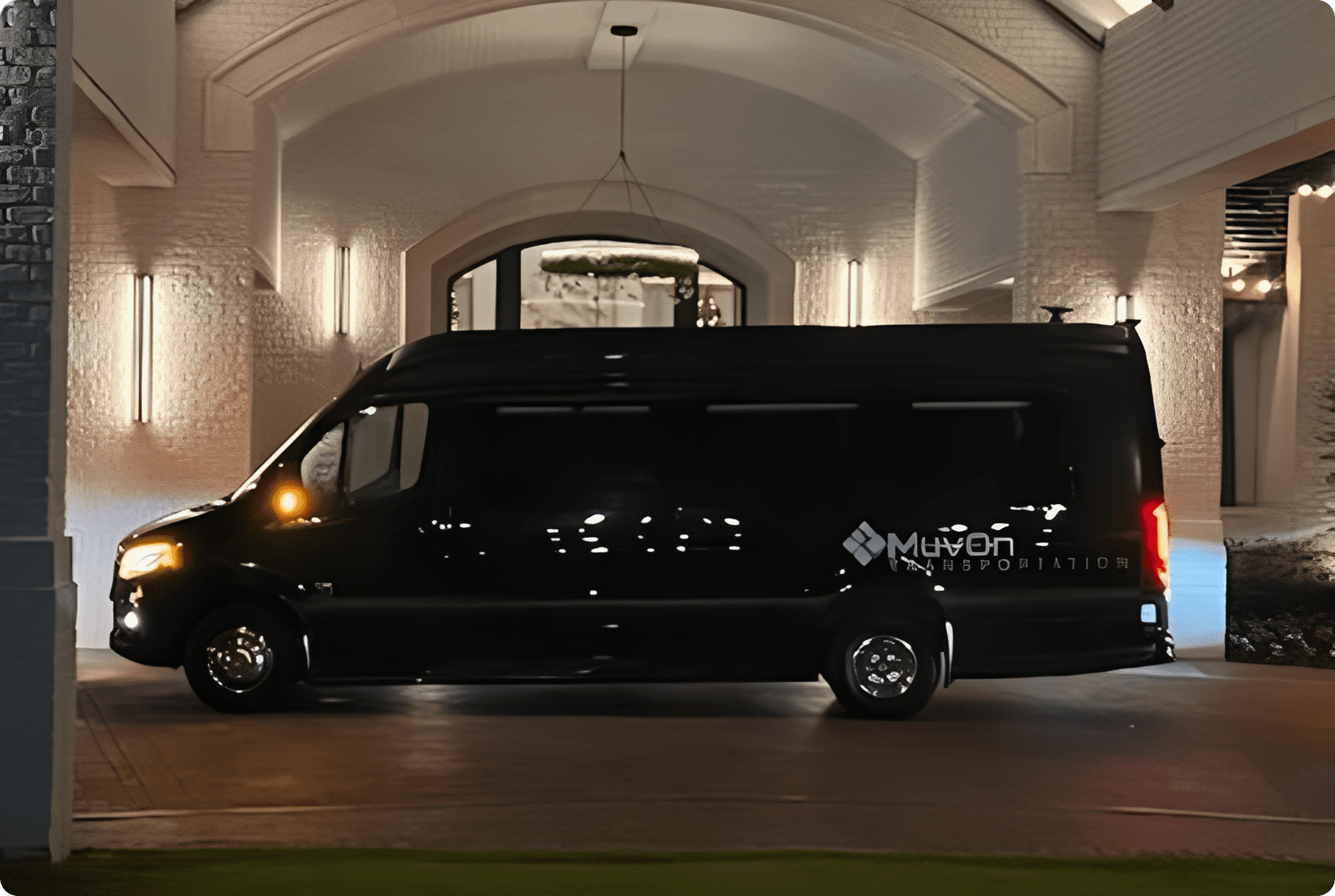 Van with logo under illuminated archway