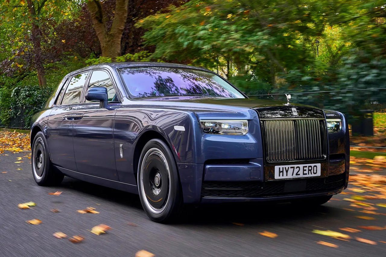 Luxury Rolls-Royce Phantom driving through autumn leaves